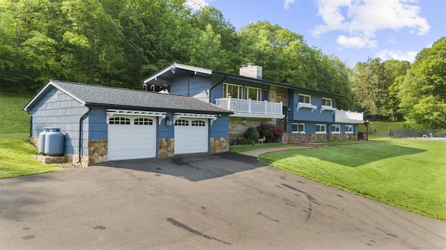 408 Stage Coach Rd, Durham, CT 06422 - view of front of property featuring a chimney, stone siding, a front lawn, asphalt driveway, and a shingled roof