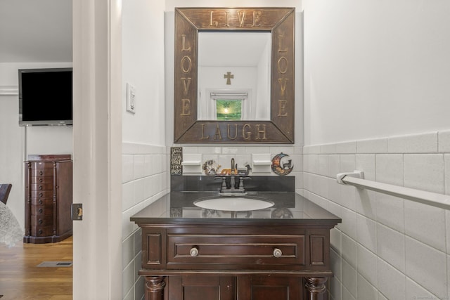 408 Stage Coach Rd, Durham, CT 06422 - bathroom with tile walls, vanity, a wainscoted wall, and wood finished floors