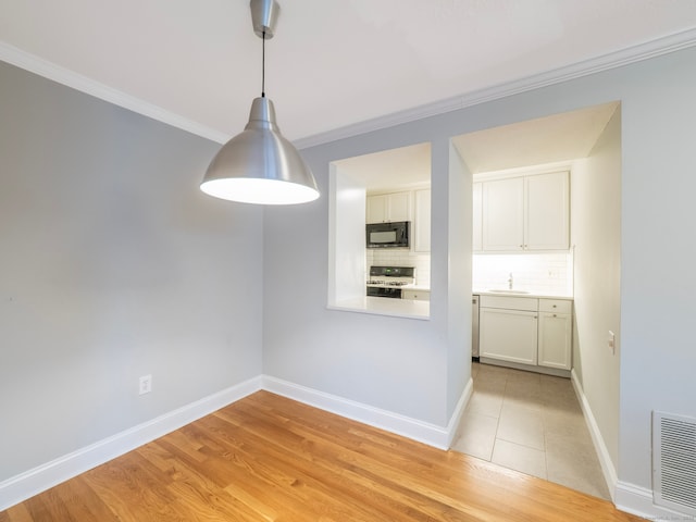3 Orange Ln Unit 3, Ridgefield, CT 06877 - unfurnished dining area featuring crown molding and light wood finished floors