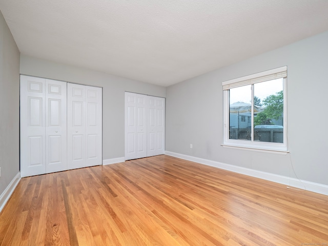 3 Orange Ln Unit 3, Ridgefield, CT 06877 - unfurnished bedroom featuring two closets and light wood finished floors