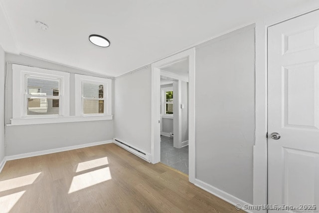 25 W Coit St, New London, CT 06320 - empty room with a baseboard radiator, wood finished floors, and baseboards