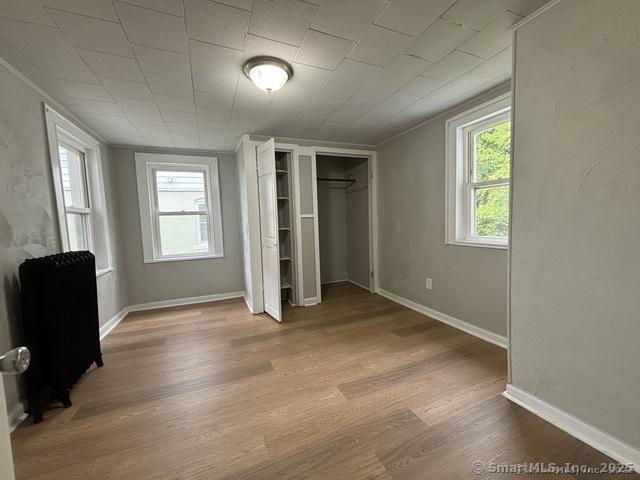 25 W Coit St, New London, CT 06320 - unfurnished bedroom with wood finished floors and baseboards