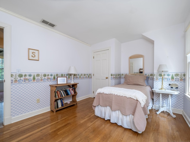 104 Scarlet Oak Dr, Wilton, CT 06897 - bedroom with wainscoting, wood finished floors, arched walkways, and ornamental molding