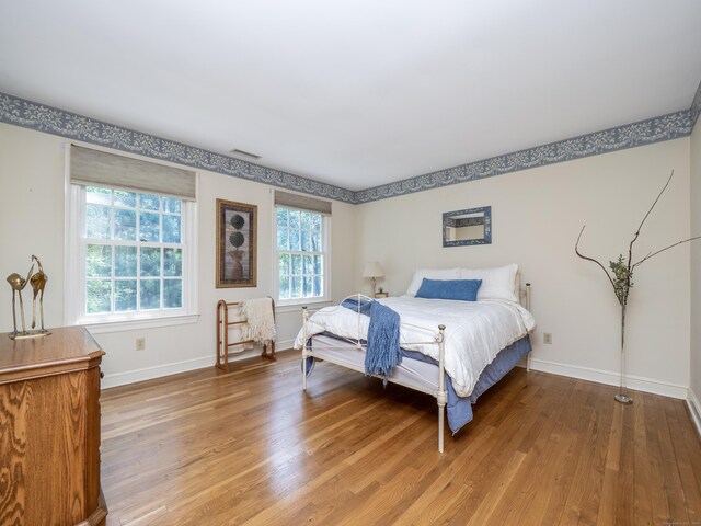104 Scarlet Oak Dr, Wilton, CT 06897 - bedroom with multiple windows, light wood finished floors, and baseboards
