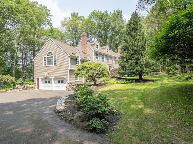 104 Scarlet Oak Dr, Wilton, CT 06897 - view of side of property featuring driveway, a chimney, a garage, and a yard