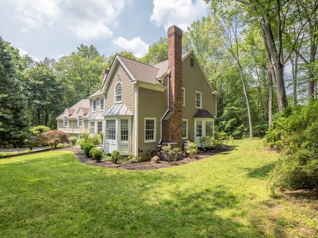 104 Scarlet Oak Dr, Wilton, CT 06897 - view of side of property featuring a chimney, a lawn, and central AC