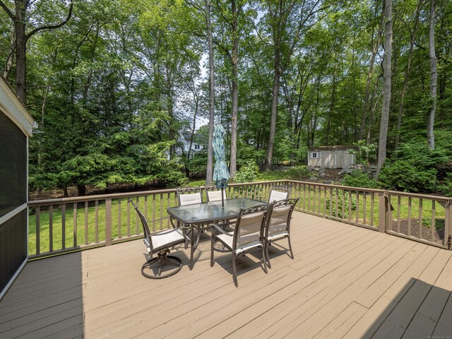 104 Scarlet Oak Dr, Wilton, CT 06897 - deck featuring outdoor dining area, a lawn, and view of wooded area