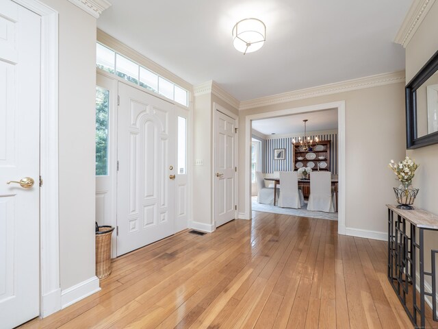 104 Scarlet Oak Dr, Wilton, CT 06897 - entryway featuring light wood-style flooring, a chandelier, baseboards, and ornamental molding