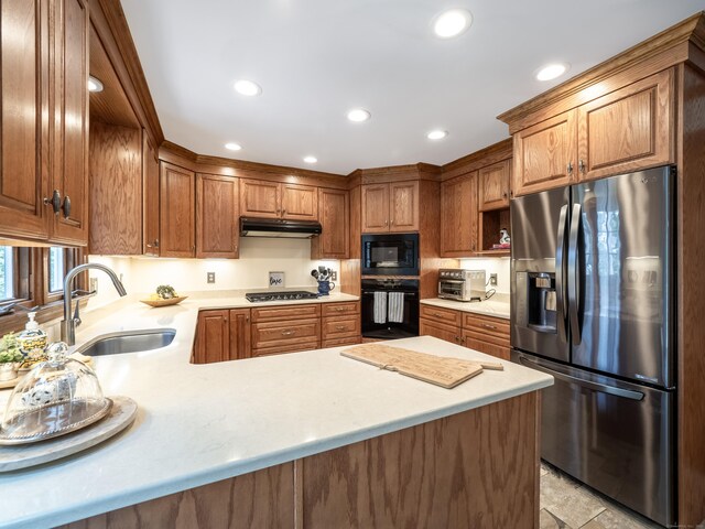 104 Scarlet Oak Dr, Wilton, CT 06897 - kitchen featuring black appliances, a sink, under cabinet range hood, light countertops, and a peninsula