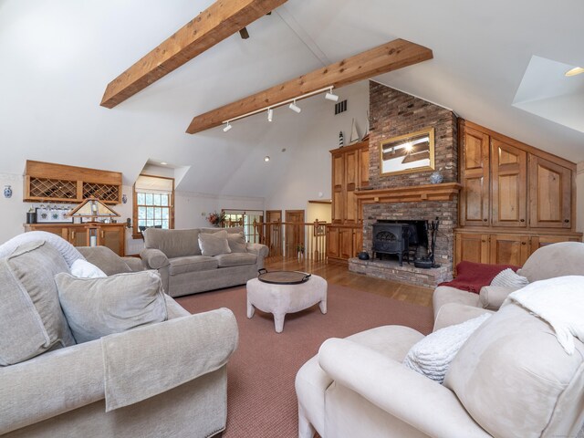 104 Scarlet Oak Dr, Wilton, CT 06897 - living room featuring beamed ceiling, wood finished floors, high vaulted ceiling, and a wood stove