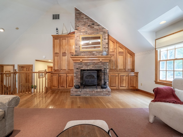 104 Scarlet Oak Dr, Wilton, CT 06897 - living area with light wood-type flooring, a wood stove, high vaulted ceiling, and baseboards