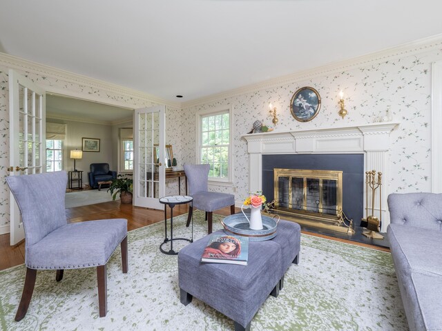 104 Scarlet Oak Dr, Wilton, CT 06897 - living area with crown molding, wallpapered walls, a glass covered fireplace, wood finished floors, and baseboards