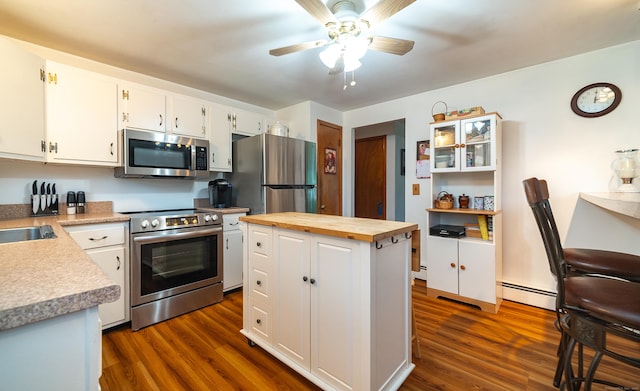 895 W Woods Rd, Hamden, CT 06518 - kitchen with stainless steel appliances, a baseboard radiator, wooden counters, and dark wood-style floors