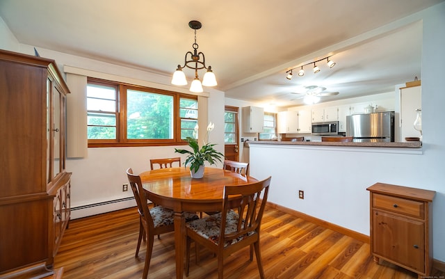 895 W Woods Rd, Hamden, CT 06518 - dining area with a baseboard radiator, wood finished floors, and ceiling fan