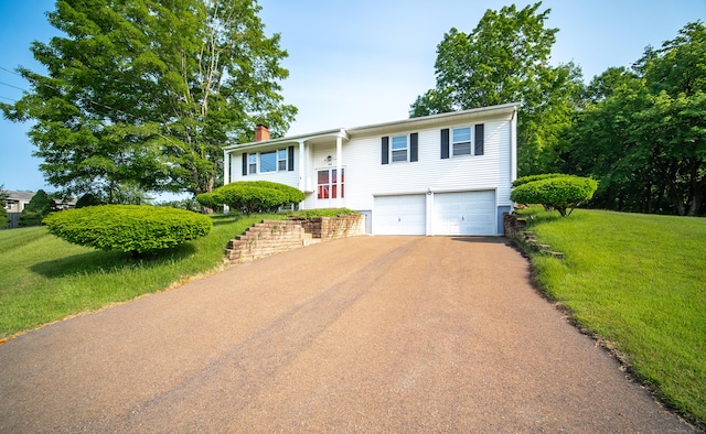 895 W Woods Rd, Hamden, CT 06518 - bi-level home with asphalt driveway, a garage, a chimney, and a front yard