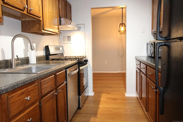 63 Niles Hill Rd Unit A4, New London, CT 06320 - kitchen with black appliances, exhaust hood, a sink, dark countertops, and light wood-style flooring