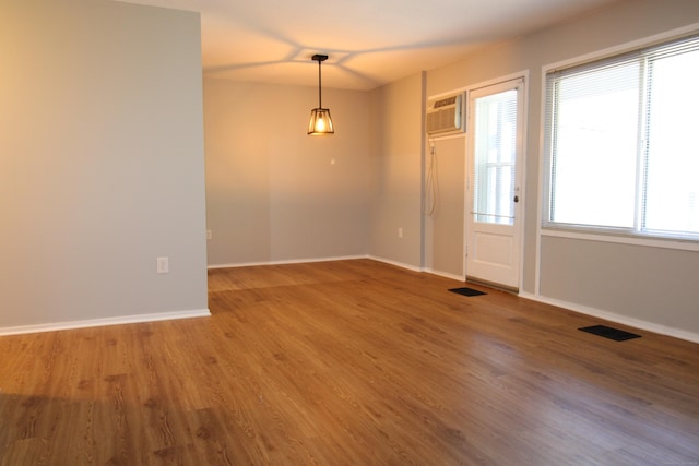 63 Niles Hill Rd Unit A4, New London, CT 06320 - spare room featuring wood finished floors, baseboards, and a wall mounted air conditioner