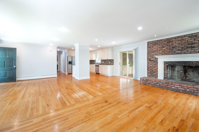 46 Columbine Dr, Trumbull, CT 06611 - unfurnished living room with crown molding, light wood-style floors, baseboards, a brick fireplace, and recessed lighting