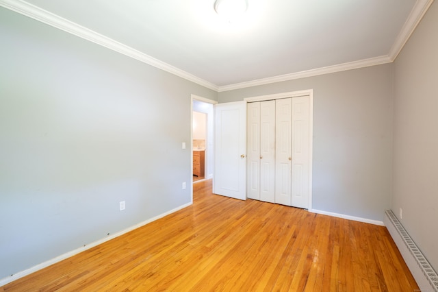 46 Columbine Dr, Trumbull, CT 06611 - unfurnished bedroom with a baseboard heating unit, light wood-style floors, baseboards, ornamental molding, and a closet