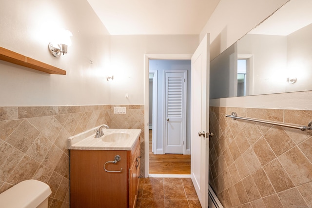 46 Columbine Dr, Trumbull, CT 06611 - bathroom featuring tile walls, vanity, toilet, a wainscoted wall, and tile patterned floors