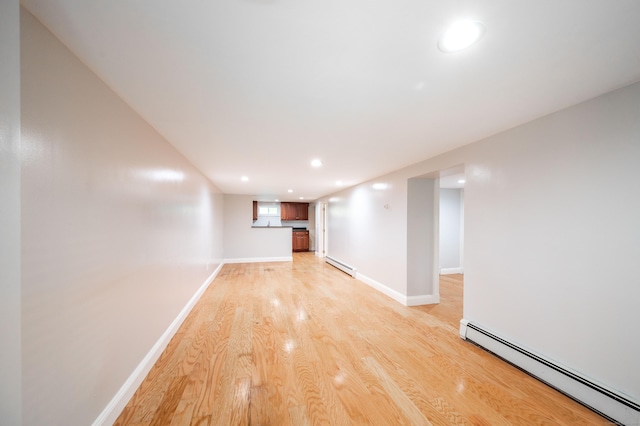 46 Columbine Dr, Trumbull, CT 06611 - finished basement with a baseboard radiator, light wood-style flooring, baseboards, and recessed lighting