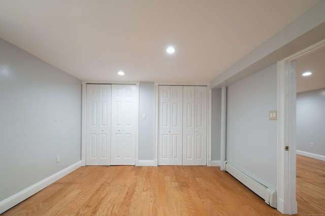 46 Columbine Dr, Trumbull, CT 06611 - unfurnished bedroom with a baseboard radiator, two closets, light wood finished floors, baseboards, and recessed lighting