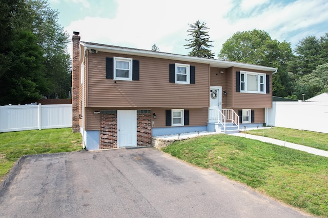 7 Pleasant St, Wolcott, CT 06716 - split foyer home featuring a chimney