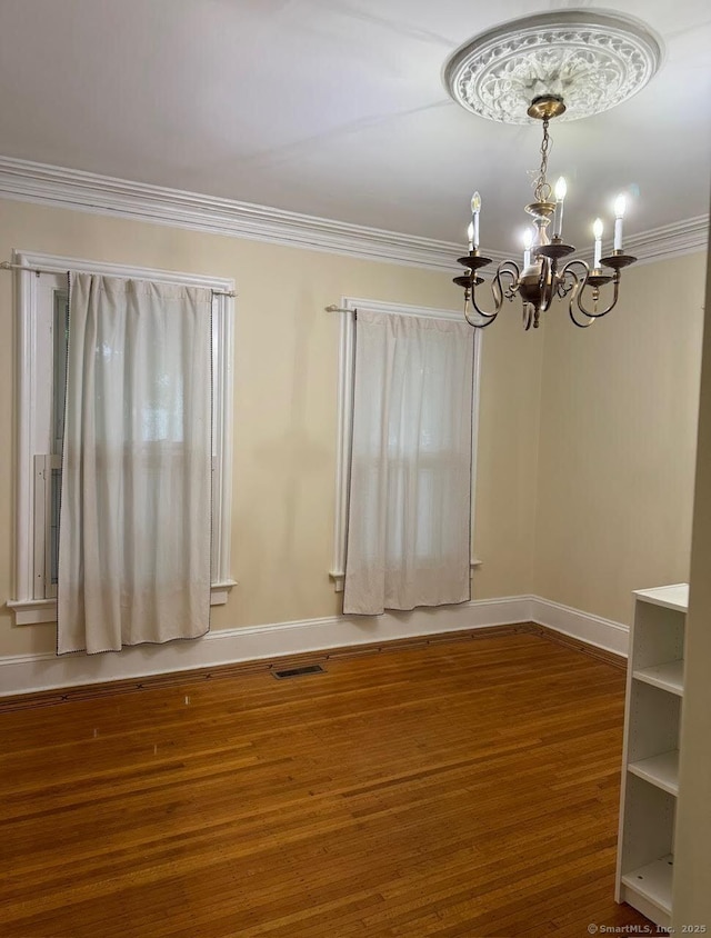 201 Center St, West Haven, CT 06516 - empty room with a chandelier, wood finished floors, crown molding, and baseboards