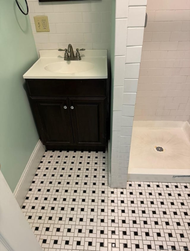 201 Center St, West Haven, CT 06516 - bathroom featuring a shower stall, vanity, backsplash, and baseboards
