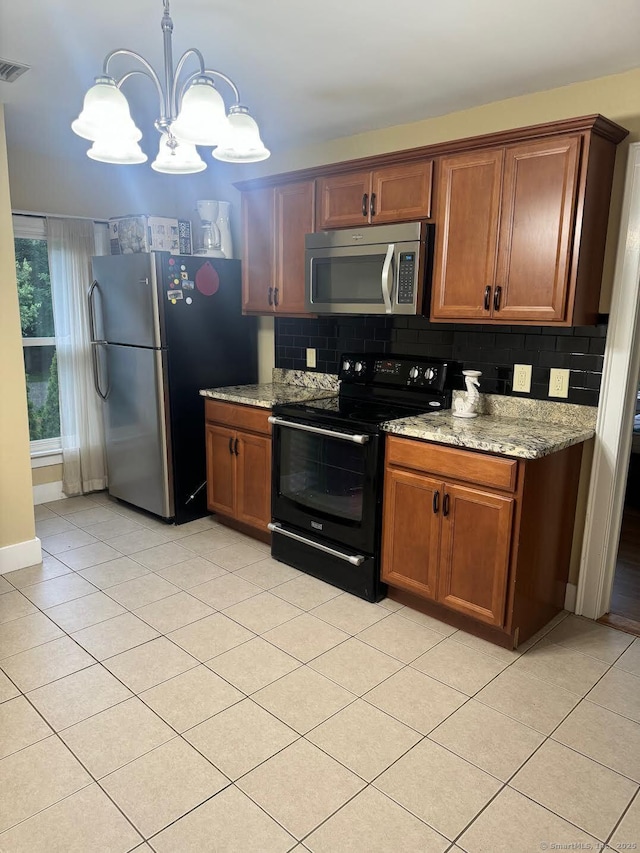 201 Center St, West Haven, CT 06516 - kitchen with appliances with stainless steel finishes, a chandelier, decorative backsplash, light stone counters, and light tile patterned floors