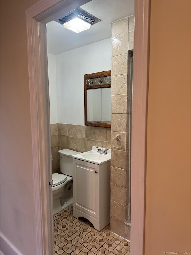 201 Center St, West Haven, CT 06516 - bathroom with tile walls, vanity, toilet, and tile patterned flooring