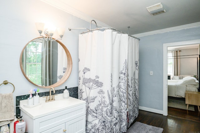 189 Broadway, Norwich, CT 06360 - bathroom featuring crown molding, vanity, hardwood / wood-style flooring, connected bathroom, and curtained shower