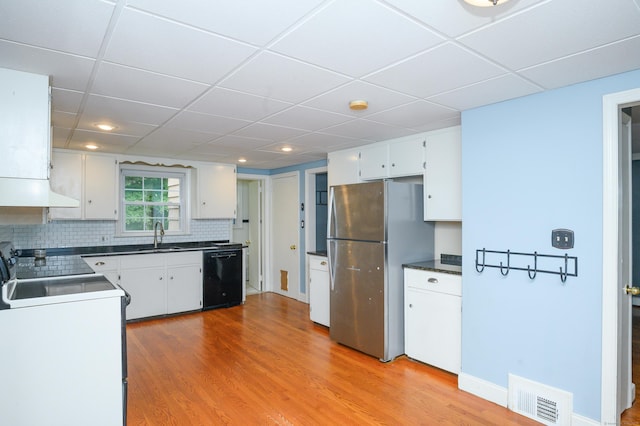 60 Old Mill Rd, Middletown, CT 06457 - kitchen featuring black dishwasher, freestanding refrigerator, stove, dark countertops, and white cabinetry