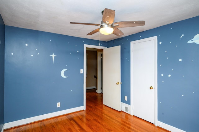 60 Old Mill Rd, Middletown, CT 06457 - unfurnished bedroom with wood finished floors, a closet, and a ceiling fan