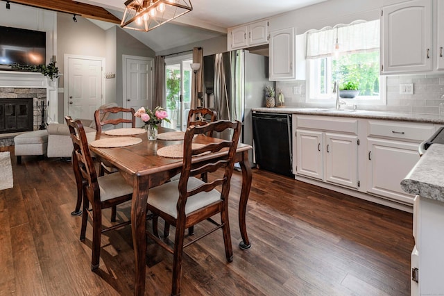 320 Spruce St, Cheshire, CT 06410 - dining space featuring vaulted ceiling, dark wood-type flooring, and a fireplace