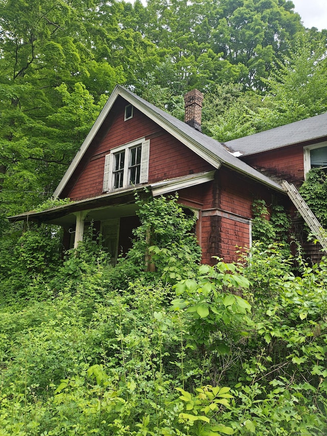 44 Main St, Essex, CT 06409 - view of side of home featuring a chimney