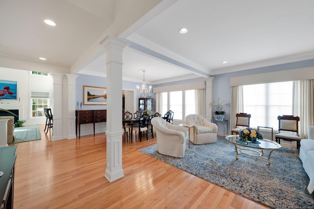 111 Thorn Hollow Rd, Cheshire, CT 06410 - living room featuring decorative columns, light wood-style floors, a chandelier, ornamental molding, and recessed lighting