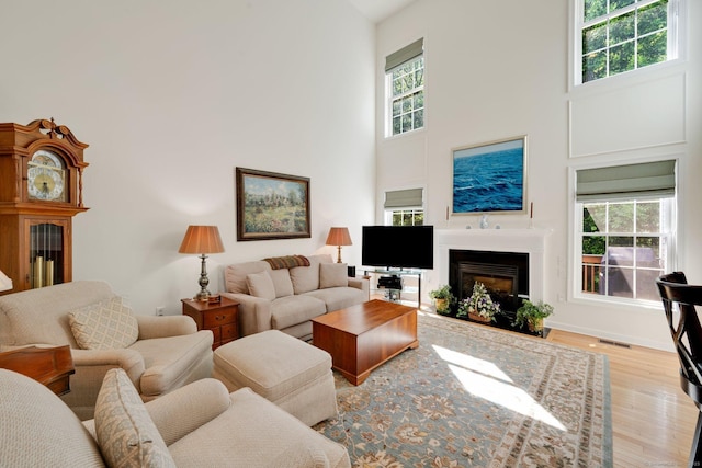111 Thorn Hollow Rd, Cheshire, CT 06410 - living room with a towering ceiling, healthy amount of natural light, wood finished floors, and a fireplace