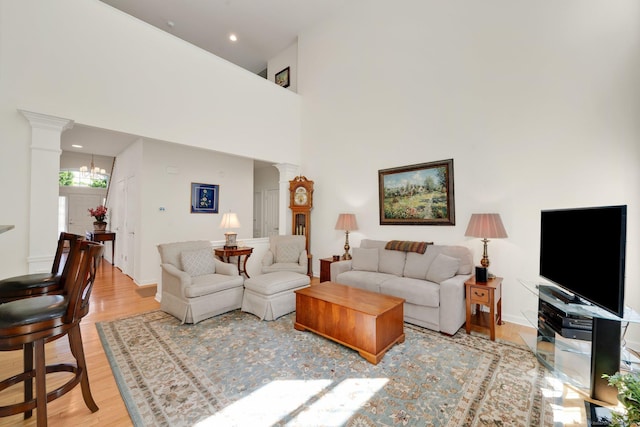 111 Thorn Hollow Rd, Cheshire, CT 06410 - living area with ornate columns, light wood-style flooring, and a high ceiling