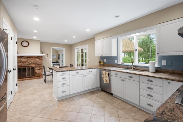68 Mopus Bridge Rd, Ridgefield, CT 06877 - kitchen featuring stainless steel appliances, a peninsula, recessed lighting, white cabinetry, and dark stone countertops