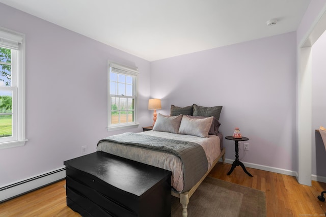 68 Mopus Bridge Rd, Ridgefield, CT 06877 - bedroom with a baseboard heating unit and light wood-style flooring