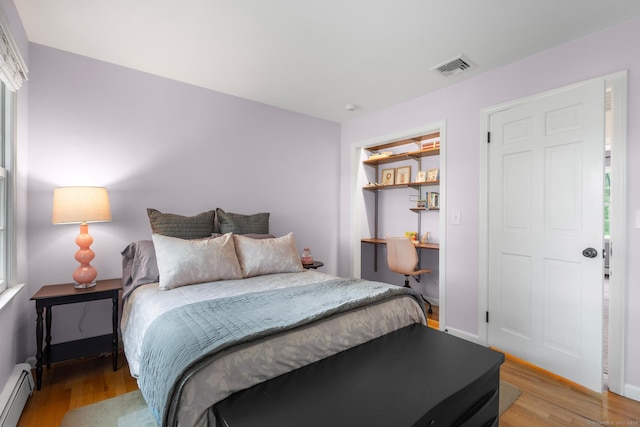 68 Mopus Bridge Rd, Ridgefield, CT 06877 - bedroom with a baseboard heating unit and light wood-type flooring