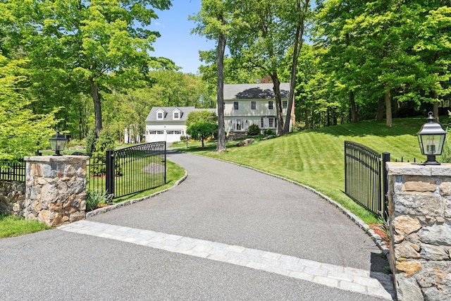 68 Mopus Bridge Rd, Ridgefield, CT 06877 - view of front of house featuring asphalt driveway, a garage, a gate, and view of scattered trees