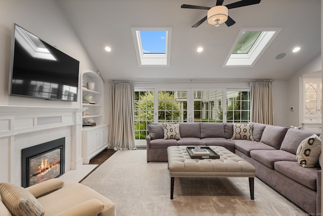 133 Buttery Rd, New Canaan, CT 06840 - living room with a skylight, a glass covered fireplace, plenty of natural light, recessed lighting, and ceiling fan