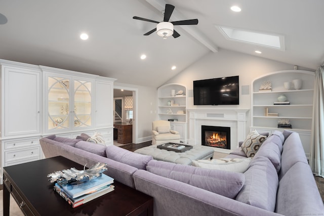 133 Buttery Rd, New Canaan, CT 06840 - living room with a ceiling fan, built in shelves, a warm lit fireplace, recessed lighting, and a skylight