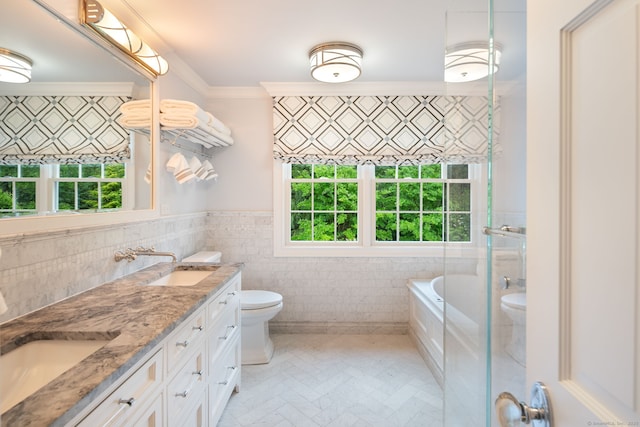 133 Buttery Rd, New Canaan, CT 06840 - bathroom featuring healthy amount of natural light, double vanity, tile walls, ornamental molding, and a wainscoted wall