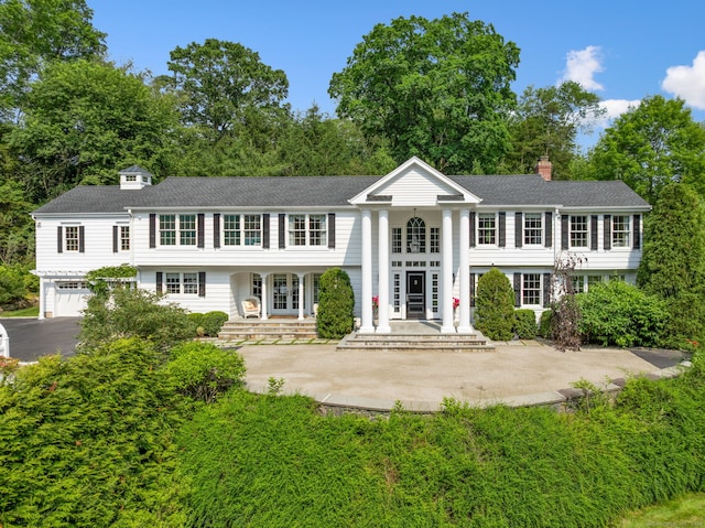 133 Buttery Rd, New Canaan, CT 06840 - view of front of home featuring french doors, a garage, a chimney, asphalt driveway, and roof with shingles