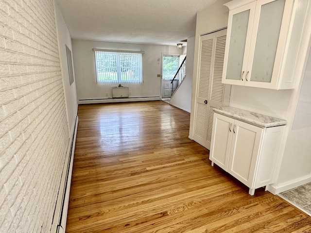 24 Woodward Ave Apt 19, New Haven, CT 06512 - corridor with baseboard heating, light wood-type flooring, and stairway