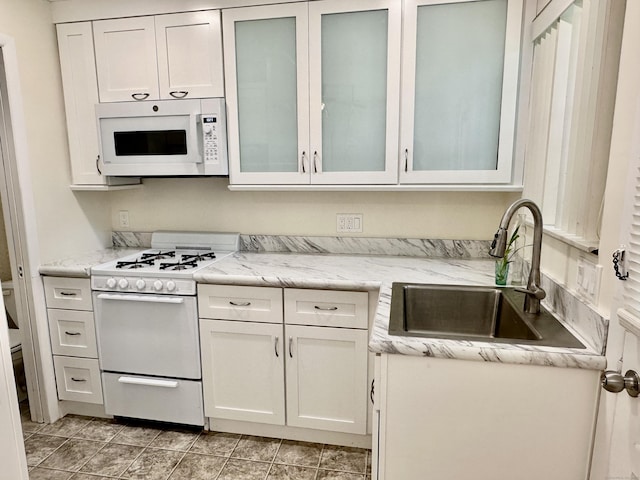 24 Woodward Ave Apt 19, New Haven, CT 06512 - kitchen with white appliances, white cabinets, glass insert cabinets, and light stone countertops