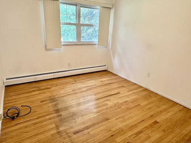 24 Woodward Ave Apt 19, New Haven, CT 06512 - unfurnished room featuring a baseboard heating unit and wood finished floors
